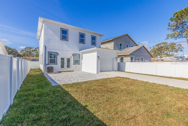 back of property with french doors, a yard, a patio area, and cooling unit