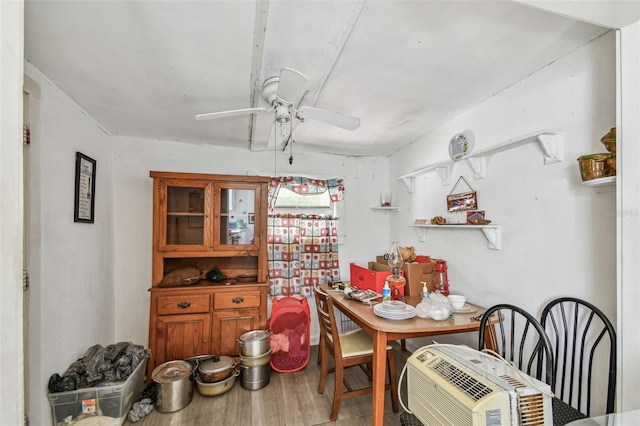 dining space with wood-type flooring and ceiling fan