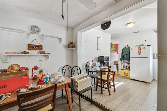 dining space featuring light wood-type flooring