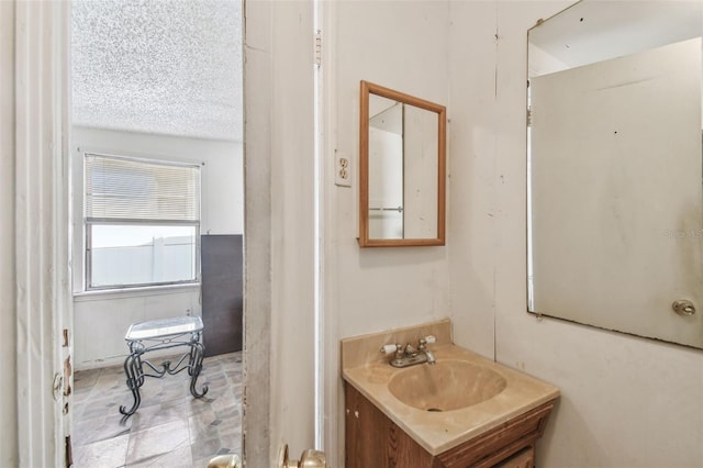 bathroom with vanity and a textured ceiling