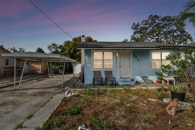 bungalow-style house featuring a storage unit