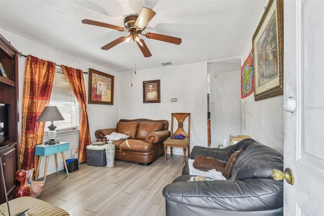 living room featuring ceiling fan and light wood-type flooring