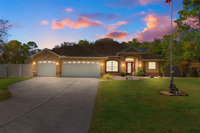 view of front facade with a lawn and a garage