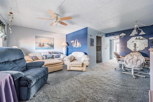 living room featuring carpet floors, a ceiling fan, a textured ceiling, and visible vents