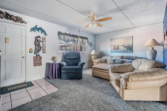 living room featuring ceiling fan and tile patterned floors
