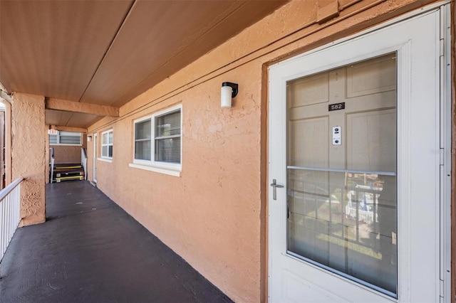 view of exterior entry featuring stucco siding