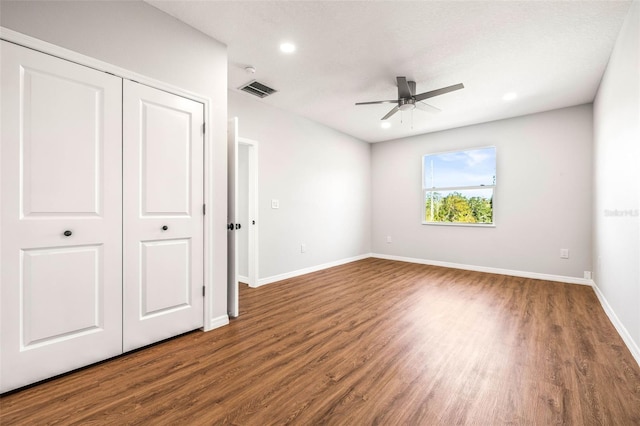 unfurnished bedroom featuring dark hardwood / wood-style floors and ceiling fan