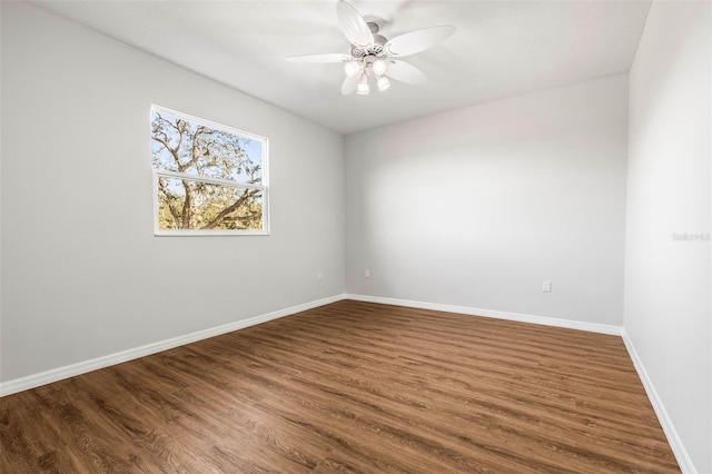 empty room featuring ceiling fan and dark hardwood / wood-style floors