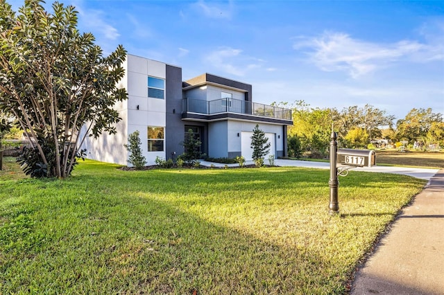 contemporary house featuring a balcony, a garage, and a front lawn