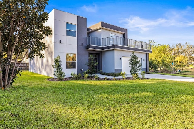 contemporary home featuring a garage, a balcony, and a front yard