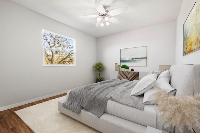 bedroom with ceiling fan and dark hardwood / wood-style floors