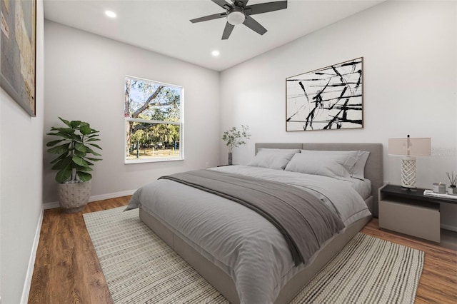 bedroom with ceiling fan and hardwood / wood-style flooring