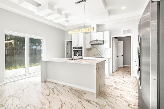 kitchen with white cabinetry, sink, hanging light fixtures, a kitchen island with sink, and appliances with stainless steel finishes