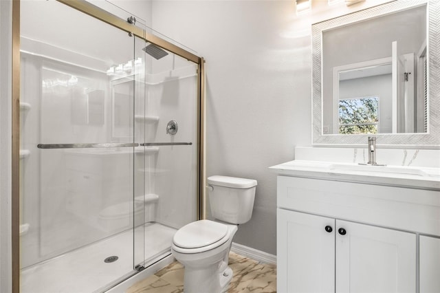 bathroom with vanity, toilet, and a shower with shower door