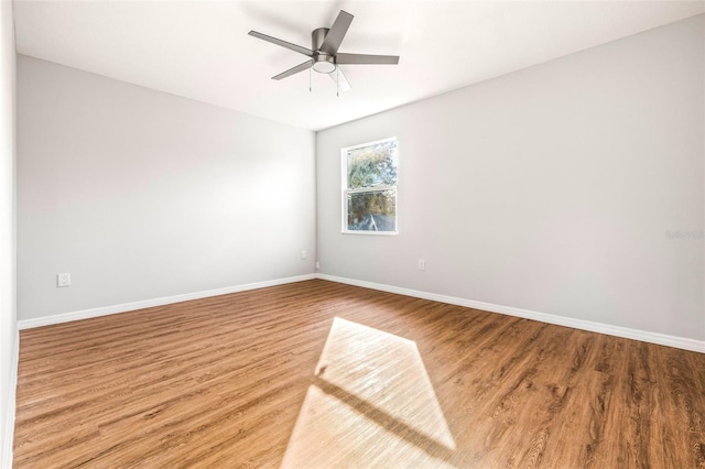 empty room featuring hardwood / wood-style flooring and ceiling fan