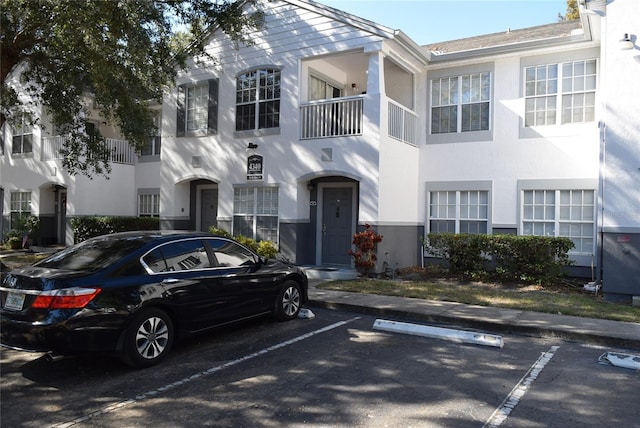 view of front of home featuring uncovered parking and stucco siding