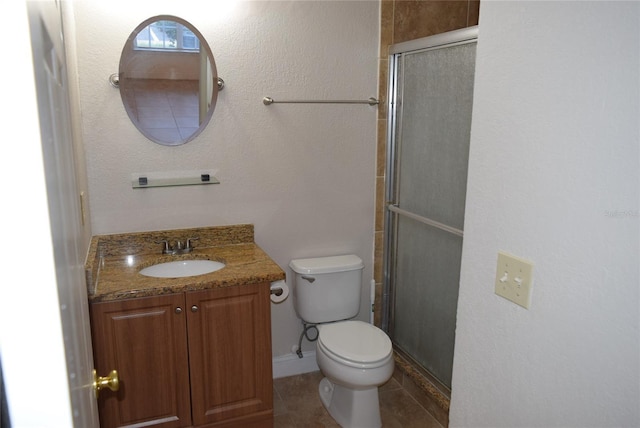 bathroom featuring vanity, an enclosed shower, and toilet