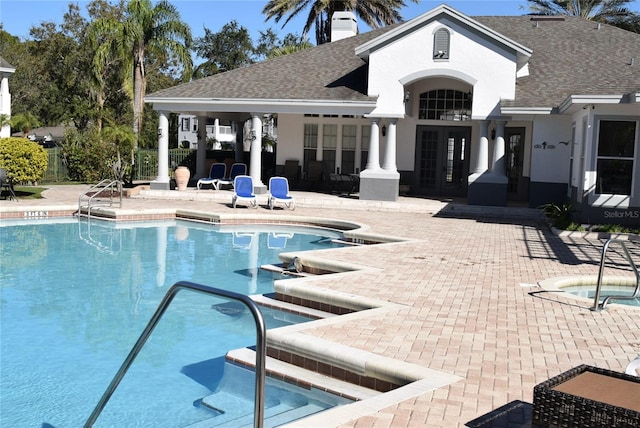 pool featuring a community hot tub, french doors, and a patio area