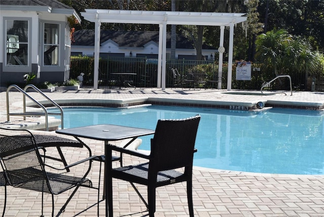 pool featuring a patio area and fence