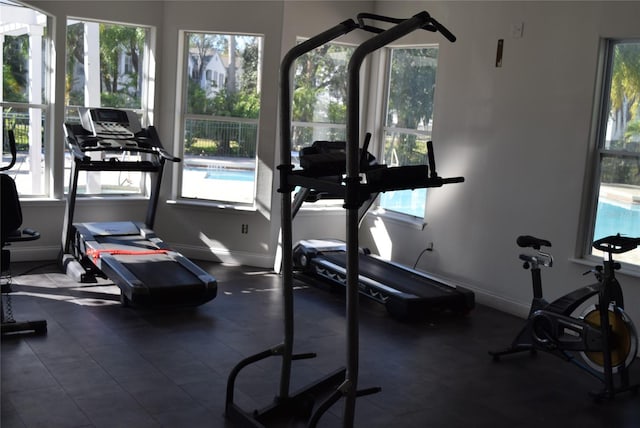 exercise room with baseboards and a wealth of natural light