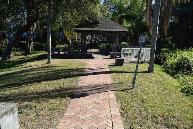 view of property's community with a lawn and a gazebo