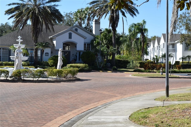 view of street with street lights and curbs