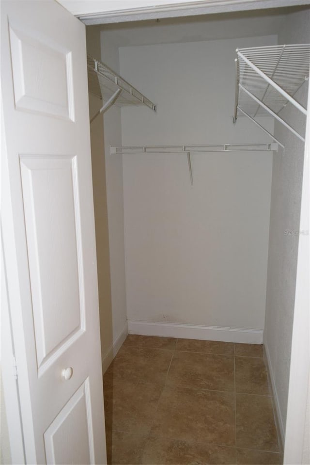 spacious closet with tile patterned floors