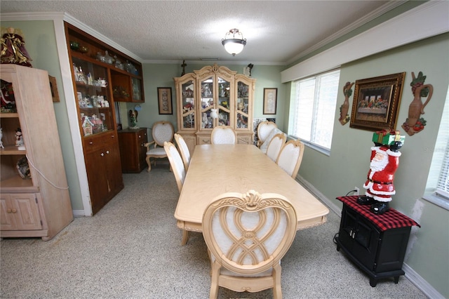 dining area with a textured ceiling and ornamental molding