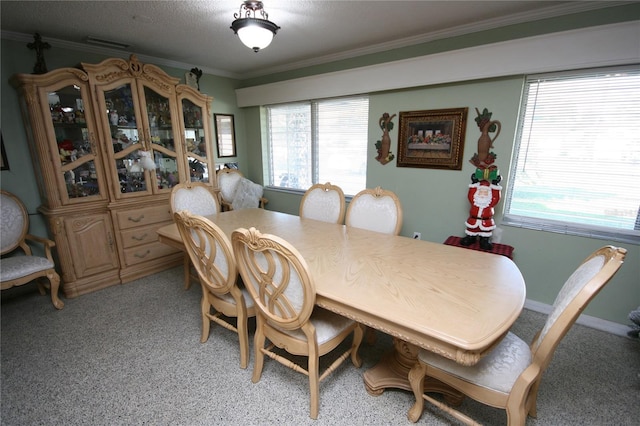 dining area with plenty of natural light and crown molding