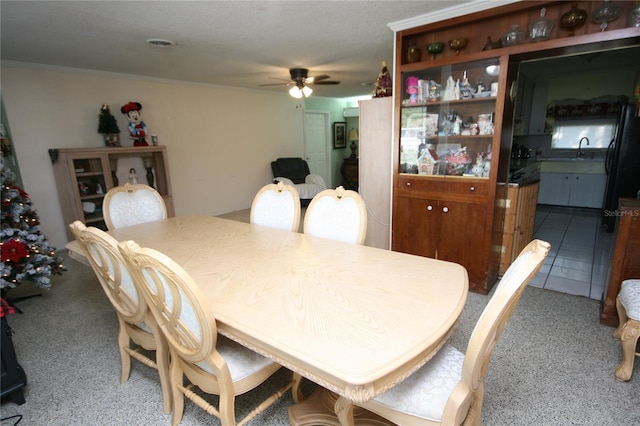 dining space with ceiling fan and sink