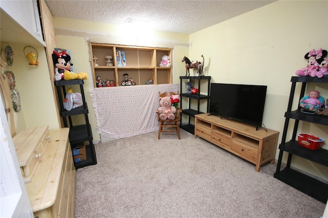 playroom with light colored carpet and a textured ceiling