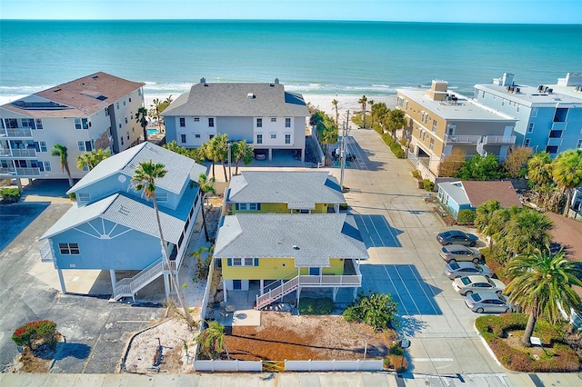 drone / aerial view featuring a water view and a view of the beach