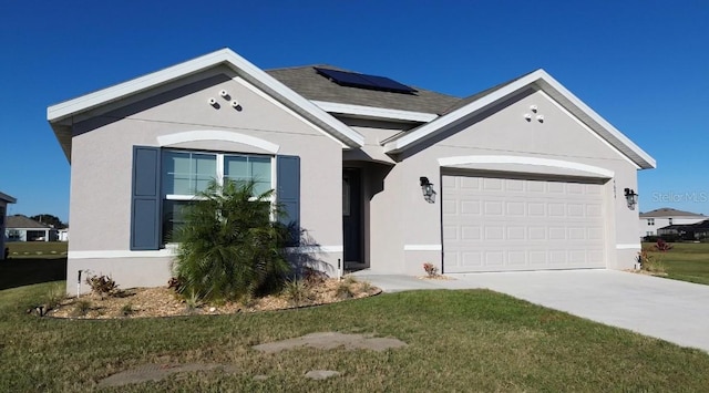 ranch-style house featuring a front yard, solar panels, and a garage