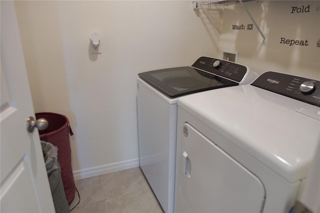 laundry area featuring light tile patterned flooring and independent washer and dryer