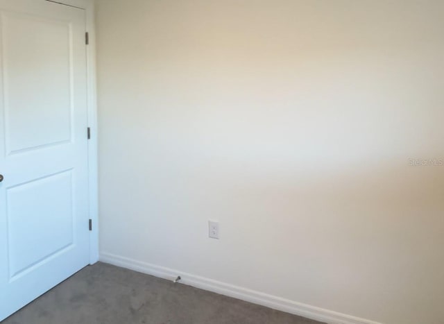4694 Sigcom Pl, Wildwood, FL 34785 - unfurnished room featuring dark colored carpet and baseboards