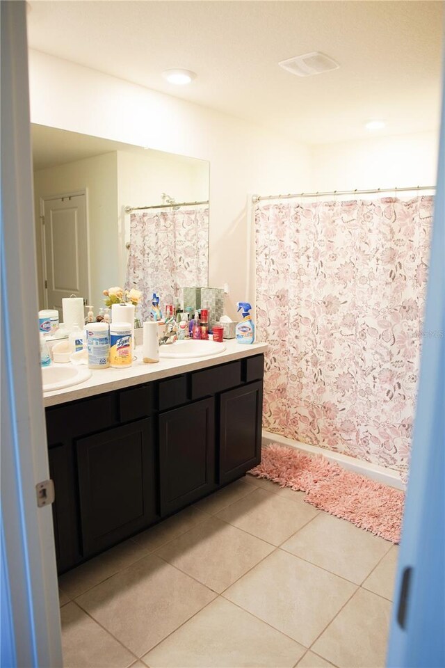 4694 Sigcom Pl, Wildwood, FL 34785 - full bathroom with double vanity, tile patterned floors, and curtained shower
