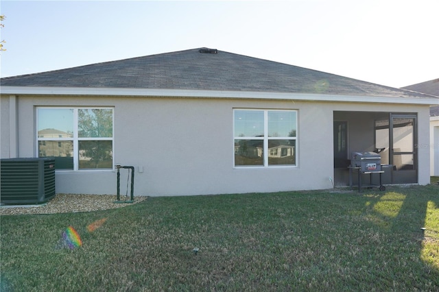 4694 Sigcom Pl, Wildwood, FL 34785 - back of house with stucco siding, roof with shingles, and a yard