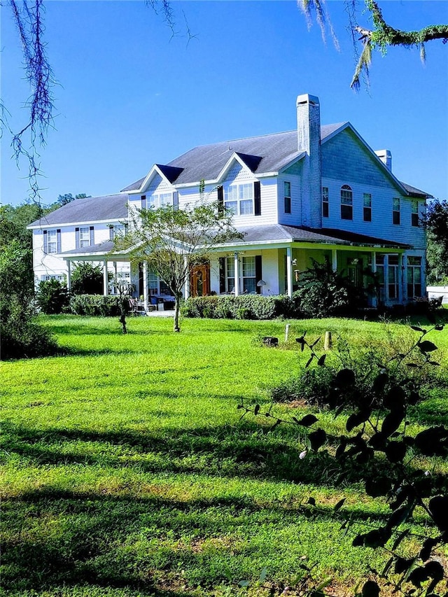 view of front of home with a front yard and a chimney