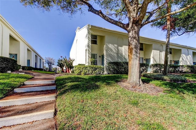 view of property exterior with a yard