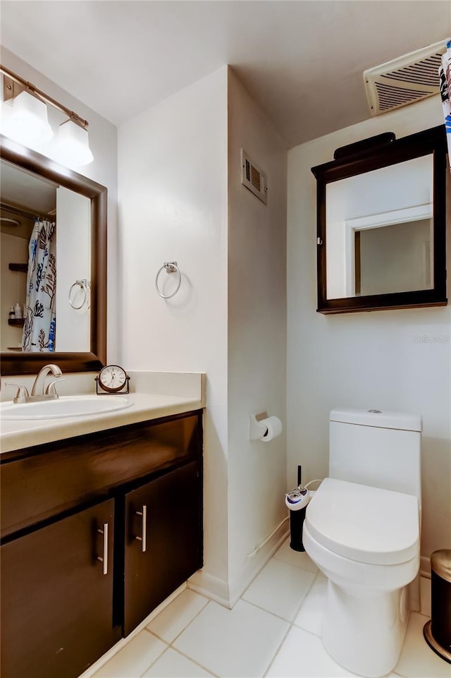 bathroom featuring vanity, toilet, and tile patterned flooring