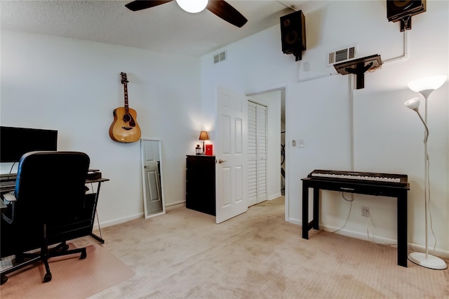 office area featuring light colored carpet, a textured ceiling, and ceiling fan