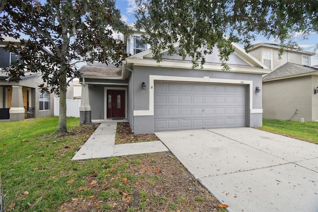 view of front facade with a garage and a front lawn