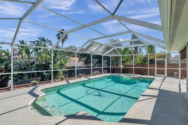 view of swimming pool with a lanai, a patio area, and an in ground hot tub