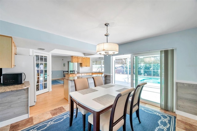 dining room featuring sink and a chandelier