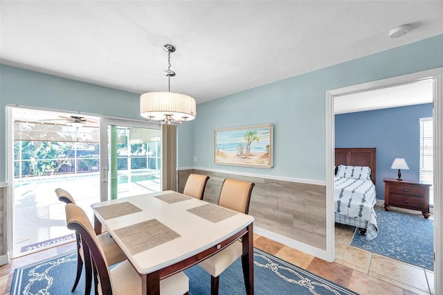 tiled dining room with plenty of natural light and ceiling fan