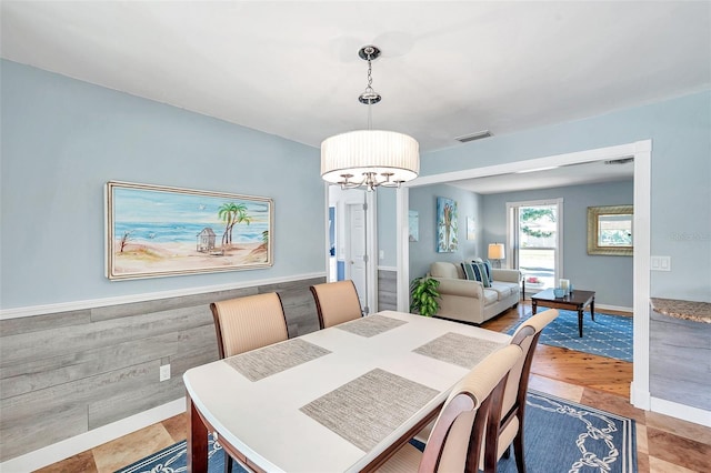 dining area with an inviting chandelier