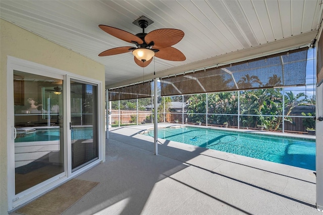 view of swimming pool with a lanai, a patio area, and ceiling fan