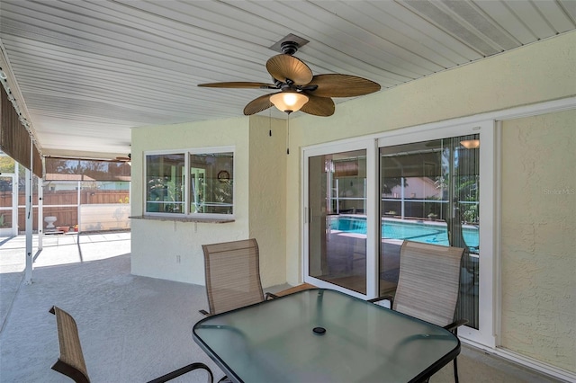 unfurnished sunroom with ceiling fan