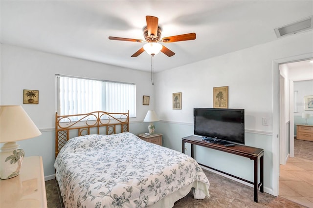 bedroom with ceiling fan and light tile patterned flooring