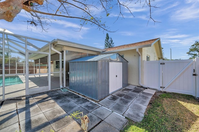 view of side of home with a lanai, a patio, and a fenced in pool